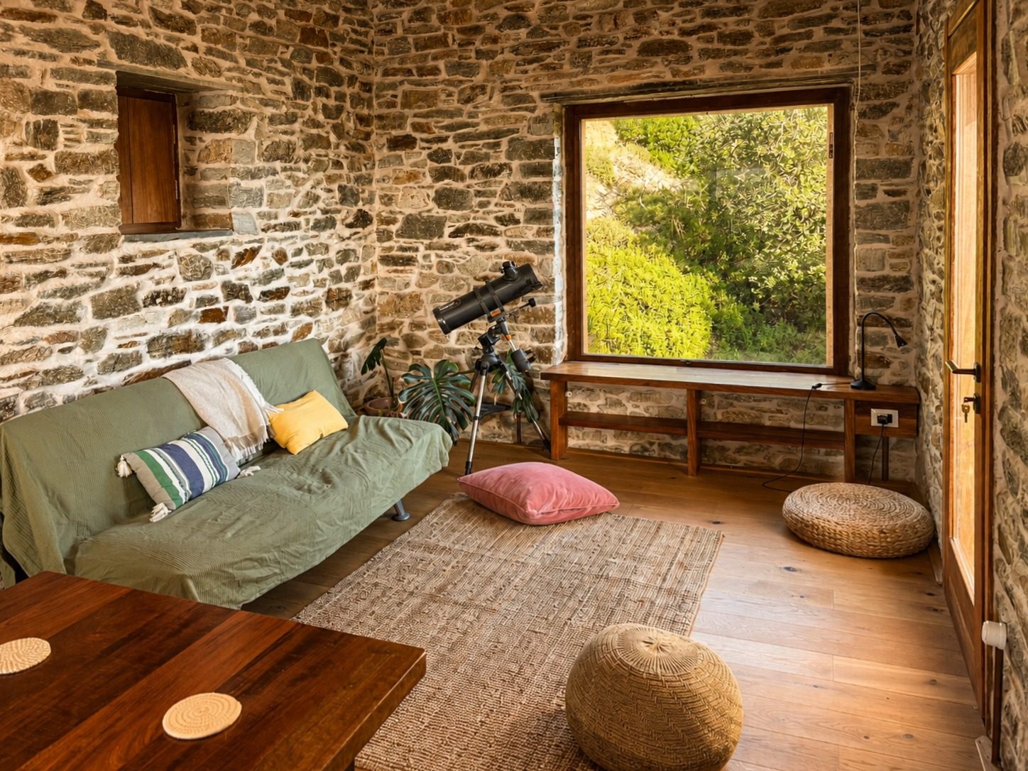 Living room with stone walls and telescope
