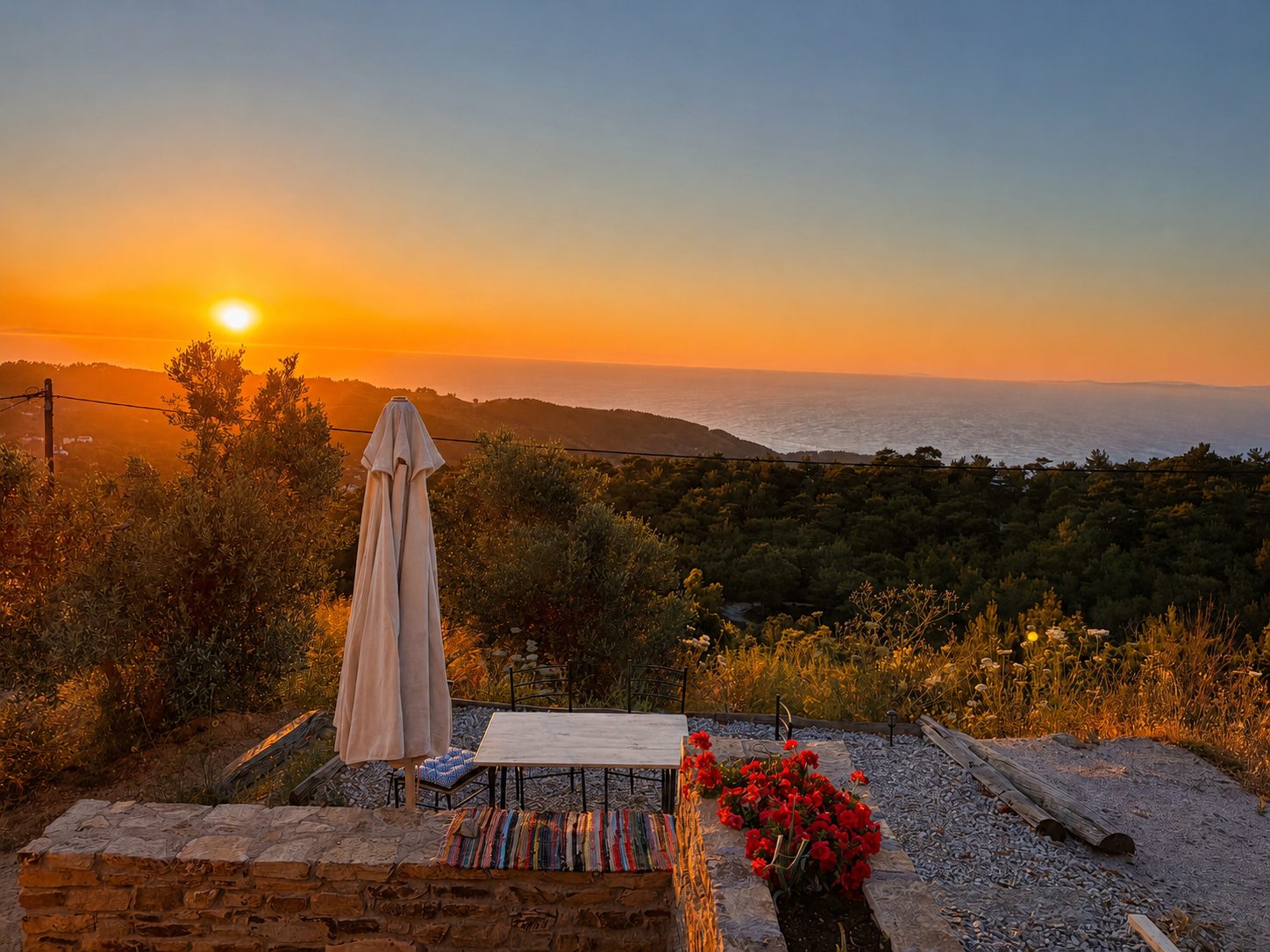 Outdoor terrace at sunset with Aegean views